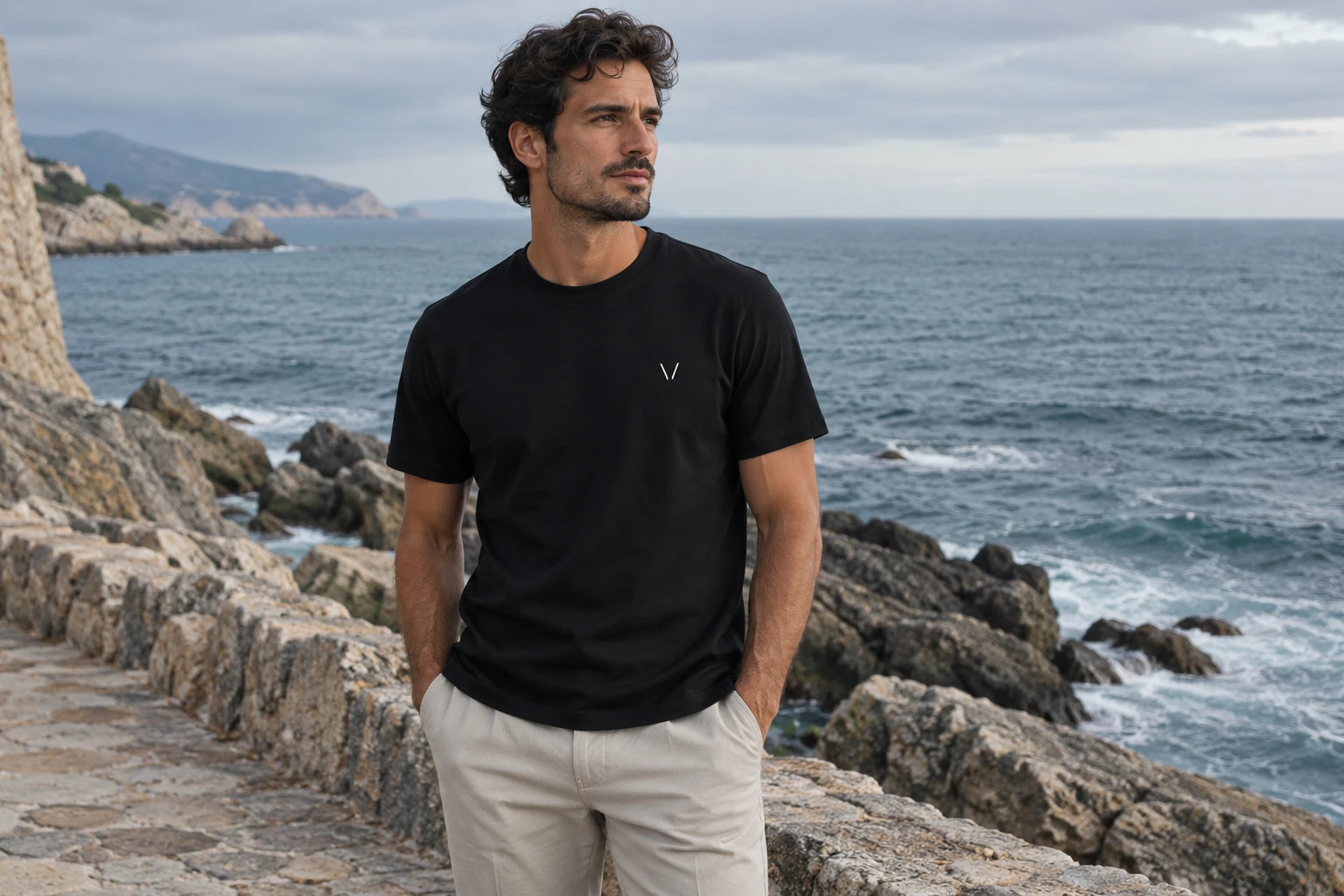 Man wearing the Ink Essential Mark Tee by the ocean